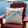 Pillow with Lake Marble Falls outline and compass on a red chair by water.