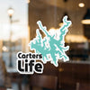 Teal map shape sticker with "Carters Life" text on a window.
