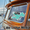 Turquoise map sticker on boat window with "Arrowhead Life" text and "Lake Lodge Media" logo.