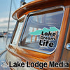A sticker on a boat's window reads "Lake Dream Life" above "Lake Lodge Media" text.