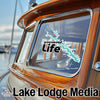 "greenwood Life" decal on boat window with "Lake Lodge Media" text below.