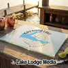 Rectangular glass cutting board featuring a blue map of Grenada Lake, Mississippi, resting on an outdoor wooden table.