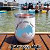 A white insulated wine tumbler with a compass graphic and the text Diamond Valley Lake California rests on a boat deck.