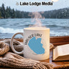 White mug with Hauser Lake Idaho map graphic, steaming hot, by rainy window.