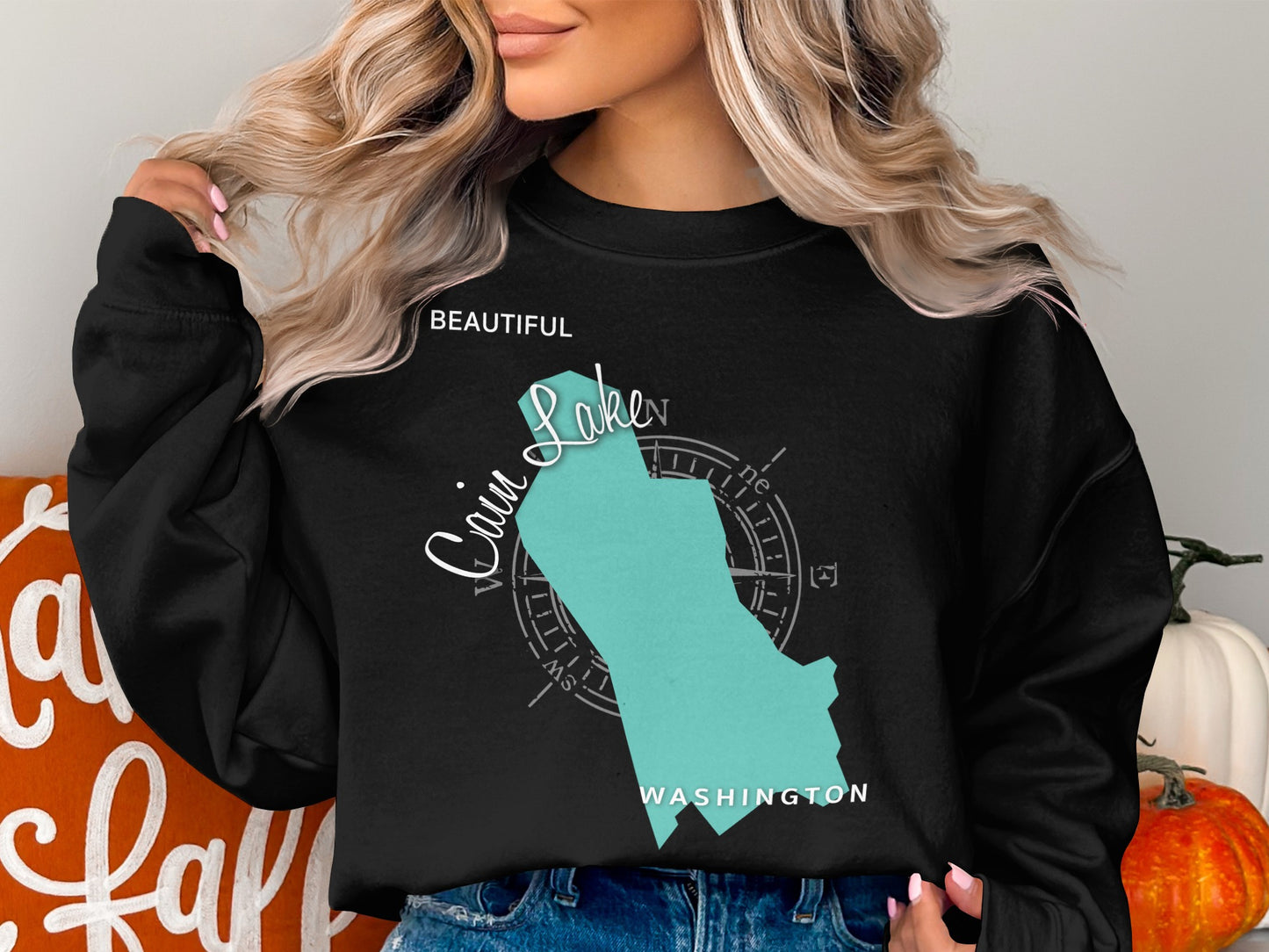 Black sweatshirt with a teal outline of Lake Chelan, Washington.