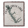 Cedar Creek Lake Texas map with compass design on a fringed woven blanket.