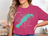 Pink t-shirt with "Beautiful Lake Marble Falls Texas" and compass design.