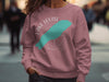 Dusty rose sweatshirt with white Lake Louise compass design and turquoise lake outline.