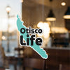 Otisco Life sticker with turquoise map outline and black text on window.