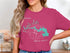Pink t-shirt with Patoka Lake compass and South Dakota map graphic.