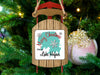 Sled ornament with "Merry Christmas FROM Lake Hefner" text and snowflakes and a pink ornament.