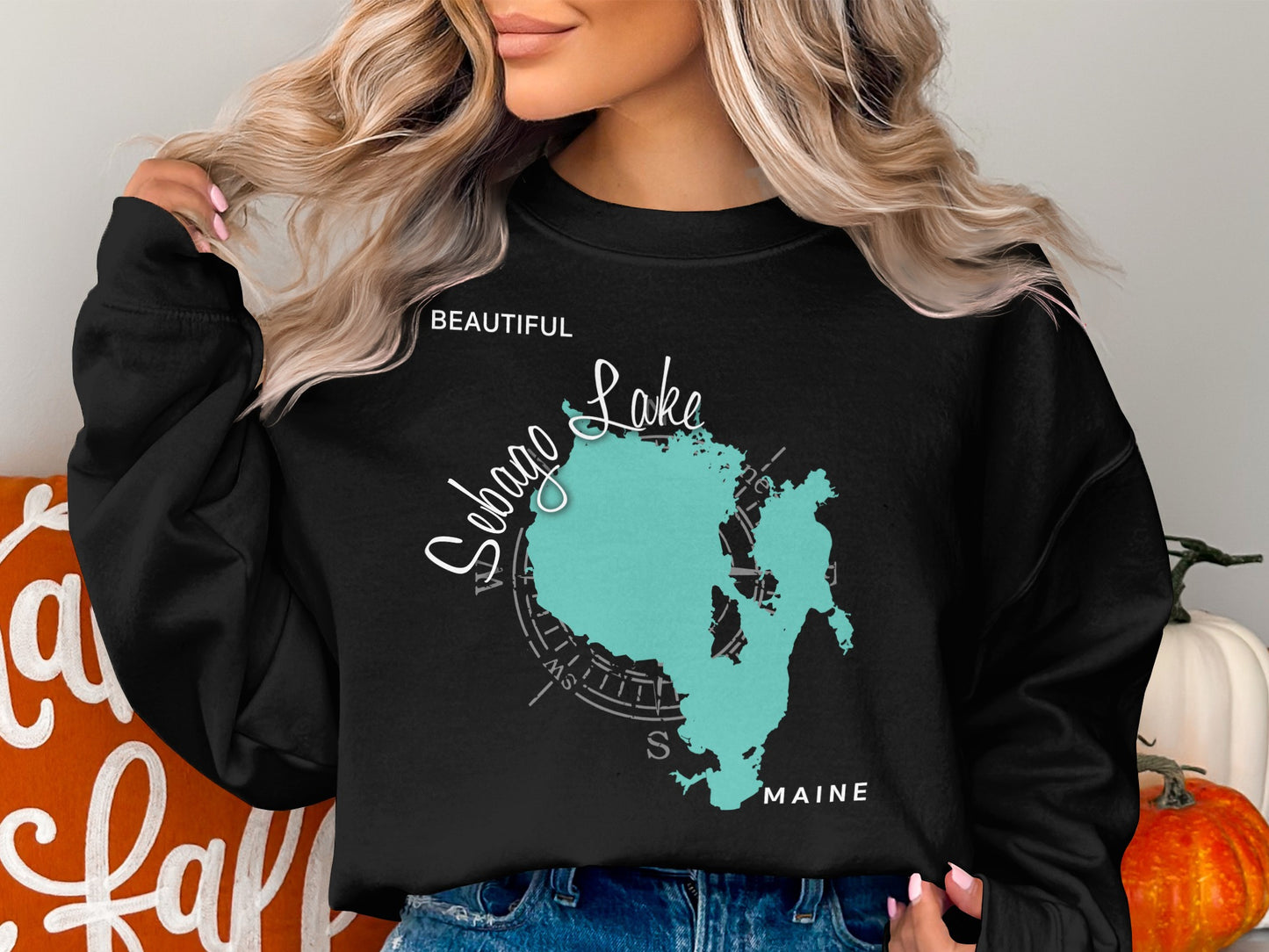 Black sweatshirt with Sebago Lake Maine map and compass design.