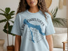 Light blue t-shirt with Lake Charlevoix map graphic over a compass rose.