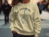 Yellow sweatshirt with "Lake Okanagan British Columbia" text and a blue river design.