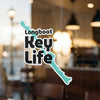 Longboat Key Life sticker over a blurred window background