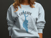 Light blue sweatshirt with a blue map of Lake Cascade, Idaho, and compass design.