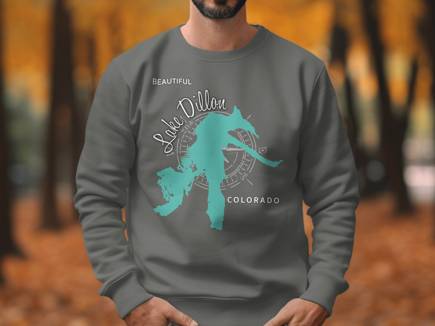 Grey sweatshirt with a teal map outline of Lake Dillon and compass graphic.