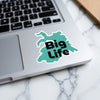 Turquoise sticker with black "Big Life" text on a laptop.