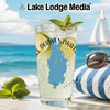 Glass with Derwentwater map, lime, mint, and ice on a beach.