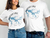 White t-shirts with "Patoka Lake Indiana" design featuring a blue lake map and compass.