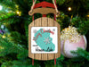 Sled ornament with "Merry Christmas FROM Hauser Lake" text on a Christmas tree.