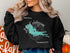 Black sweatshirt with Lake Kabekona map and compass graphic.