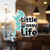 Sticker with a turquoise lake shape and text that reads "Little grassy Life".
