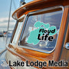 Sticker with "Floyd Life" in black text on a teal shape, on a boat window.