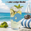 Glass of lemonade with lime and mint on a beach with sailboat.