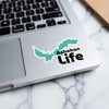 Ashokan Life sticker in turquoise map shape and black text on laptop.