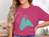 Pink t-shirt with "Lake Manawa Beautiful" text and map outline of Iowa.