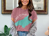 T-shirt features a teal map overlaying "Lake Quinault Washington" text and compass rose.