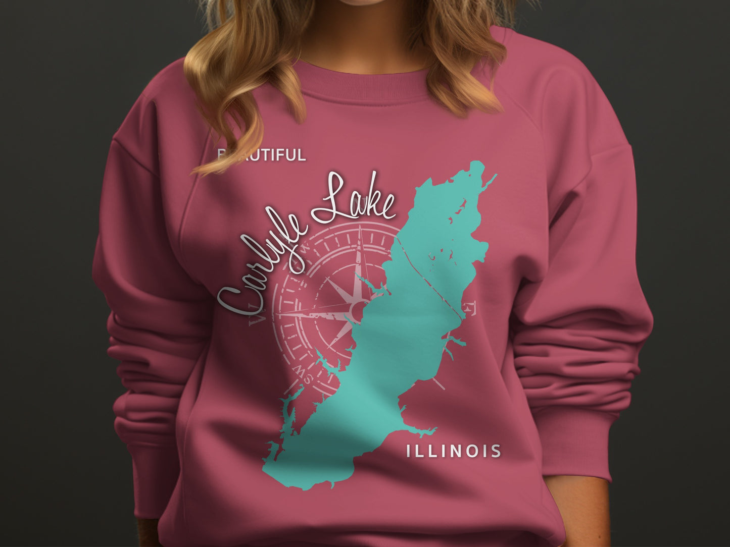 Pink sweatshirt with teal Carlysle Lake Illinois map and compass rose graphic.