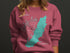 Pink sweatshirt with teal Carlysle Lake Illinois map and compass rose graphic.