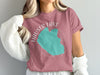 Pink t-shirt with turquoise outline of Hauser Lake, Idaho graphic and text.