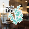 Sticker with "martin Life" text and a teal lake outline on a window.