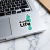 Turquoise Barlow Life sticker on a laptop keyboard with marble surface.