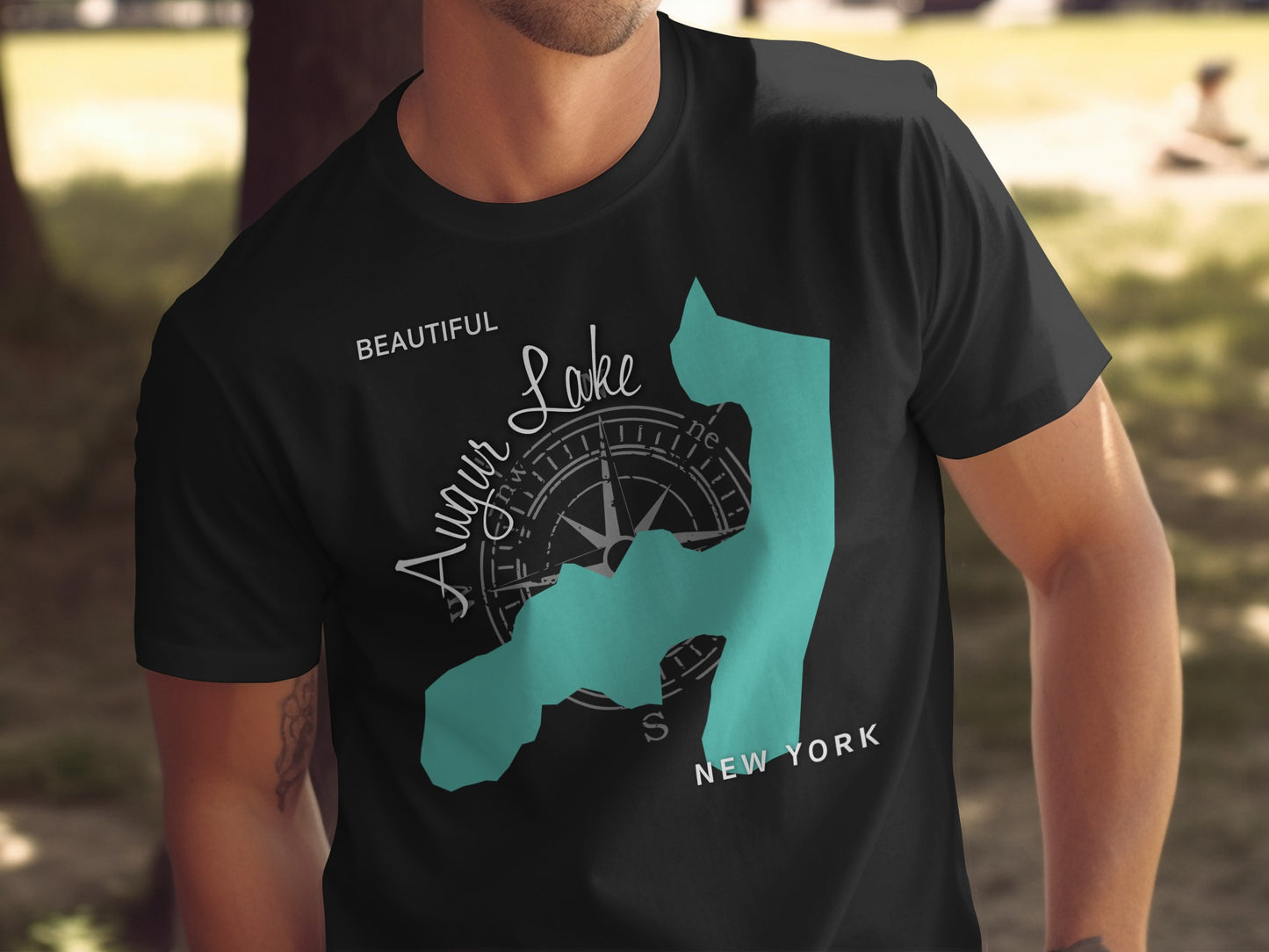 Black t-shirt with teal Augur Lake map and compass graphic.