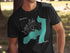 Black t-shirt with teal Augur Lake map and compass graphic.