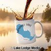 White mug with Sandhill Lake Wisconsin design, coffee pouring into it.