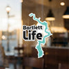 Sticker with "Bartlett Life" and a turquoise outline of a lake on a window.