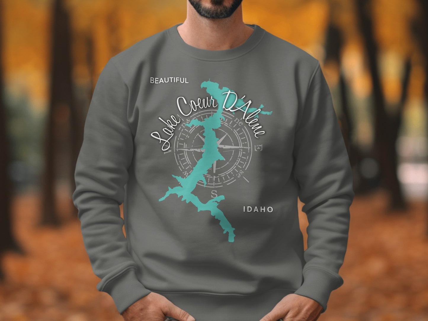 Dark gray sweatshirt with a teal Lake Coeur d'Alene map design and compass rose.