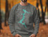 Dark gray sweatshirt with a teal Lake Coeur d'Alene map design and compass rose.