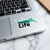 Rangeley Life sticker on a laptop keyboard with a marble background.