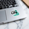 Calcasieu Life sticker on a laptop keyboard with a marbled background.
