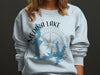 Light blue sweatshirt with Medina Lake Texas map and compass design.