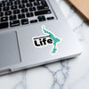 Winnisquam Life sticker on a laptop keyboard, featuring lake outline.
