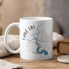 White mug with blue Lake LBJ Texas map and compass graphic, with steam.