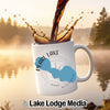 White mug with "Pearl Lake Wisconsin" design, coffee pouring into it.