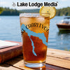 Glass with iced tea, blue map outline, and compass design by Lake Lodge Media.